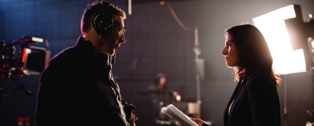 Executive producer on a film set discussing with the director during film and television production