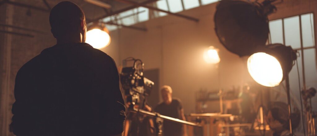 What Is a Gaffer in a Film? Roles, Skills, and Career Path Explained 1 https://blog.connactz.com/wp-content/uploads/2025/09/gaffer_filmset.jpg Gaffer works on a film set with lighting equipment and film crew during film production